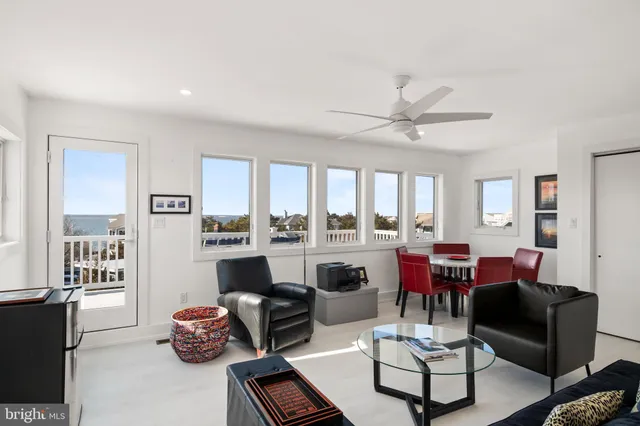 a front view of a house with a yard and potted plants
