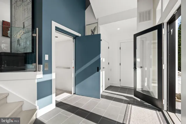 a living room with furniture a fireplace and a large window