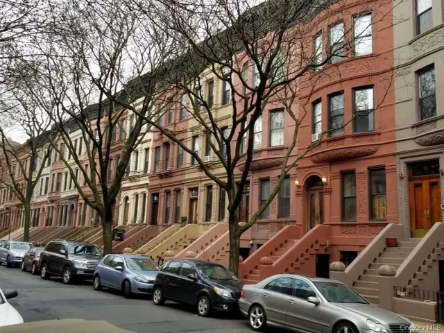 a view of a cars park in front of a building