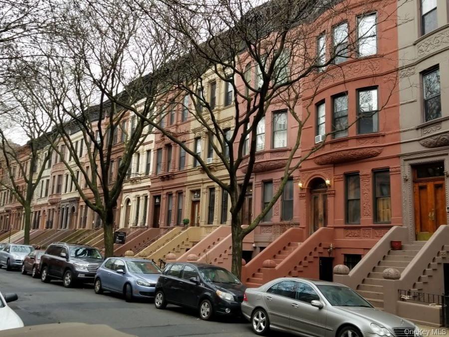 a view of a cars park in front of a building