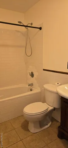 a bathroom with a toilet a sink and a shower