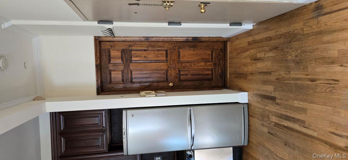 235 West 137th Street, Unit 1F Manhattan, NY 10030 - Photo 16 of 27 an empty room with wooden floor and cabinet