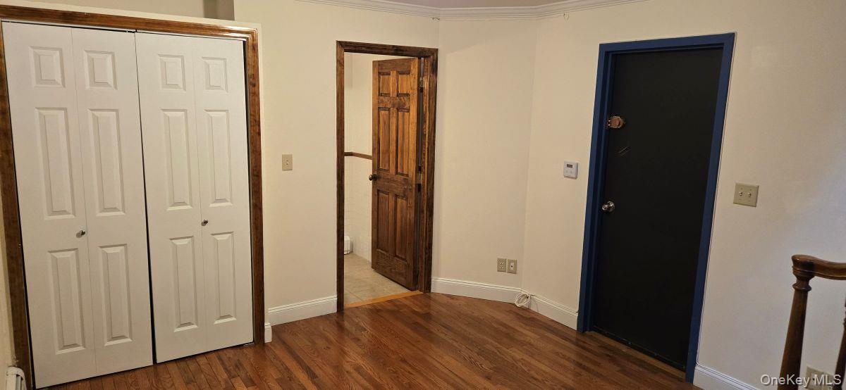 235 West 137th Street, Unit 1F Manhattan, NY 10030 - Photo 19 of 27 an empty room with wooden floor and closet