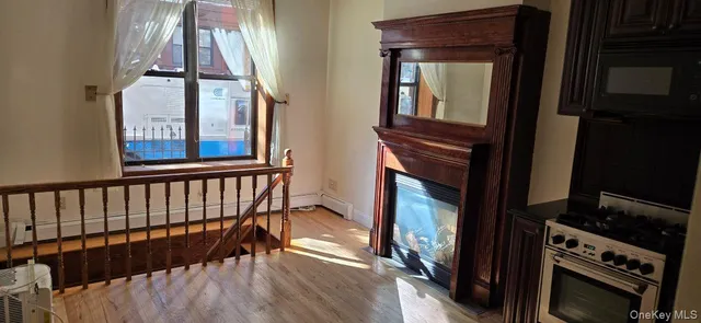 a view of hallway with a large window and wooden floor