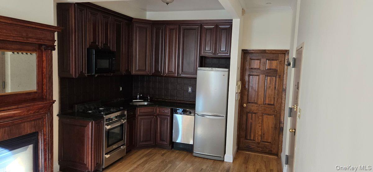 235 West 137th Street, Unit 1F Manhattan, NY 10030 - Photo 6 of 27 a kitchen with a refrigerator stove and cabinets