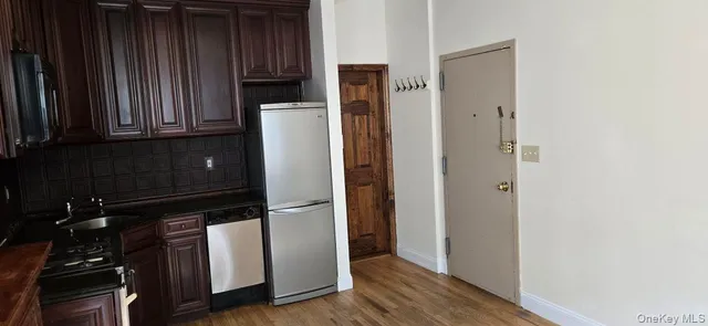 a view of walk in closet with wooden floor