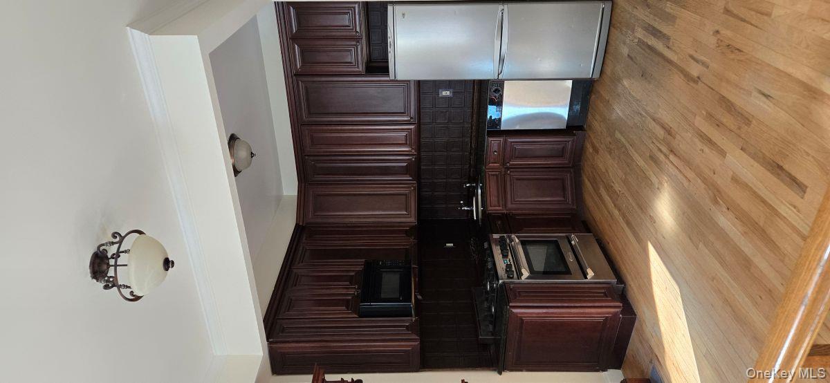 235 West 137th Street, Unit 1F Manhattan, NY 10030 - Photo 8 of 27 a kitchen with stainless steel appliances granite countertop a refrigerator a stove a sink and cabinets