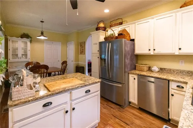 a bedroom with bed and a a chair