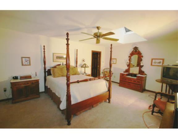397 Langen Road Lancaster, MA 01523 - Photo 9 of 16 a bed room with a bed and a chandelier