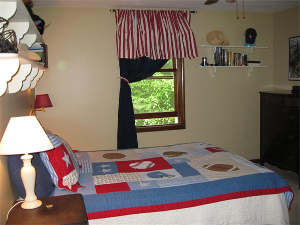 397 Langen Road Lancaster, MA 01523 - Photo 10 of 16 a living room with a bed and a flat screen tv