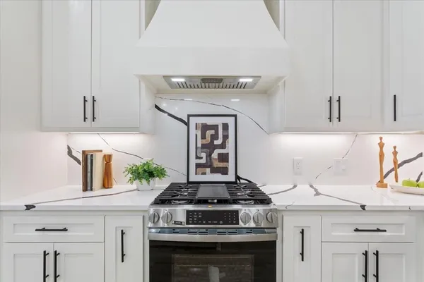 a stove top oven sitting inside of a kitchen