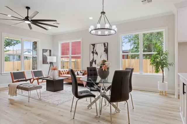 a living room with furniture a window and a chandelier