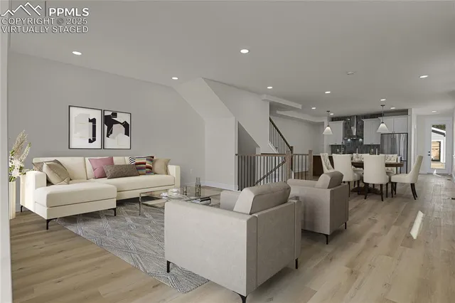 a living room with furniture and wooden floor