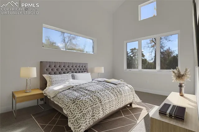 a bedroom with bed and a lamp on dresser