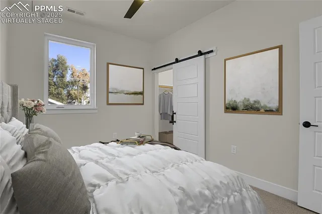 a bedroom with a bed and a painting on the wall