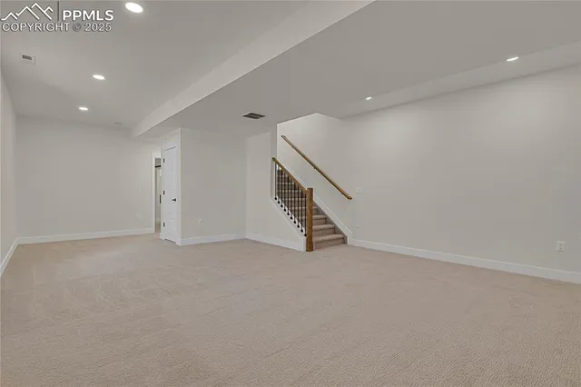 a view of an empty room with stairs