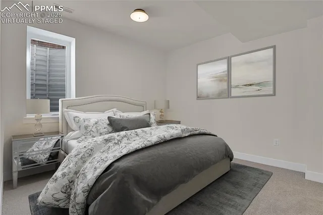 a bed sitting in a bedroom next to a window