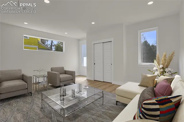a living room with furniture and a wooden floor