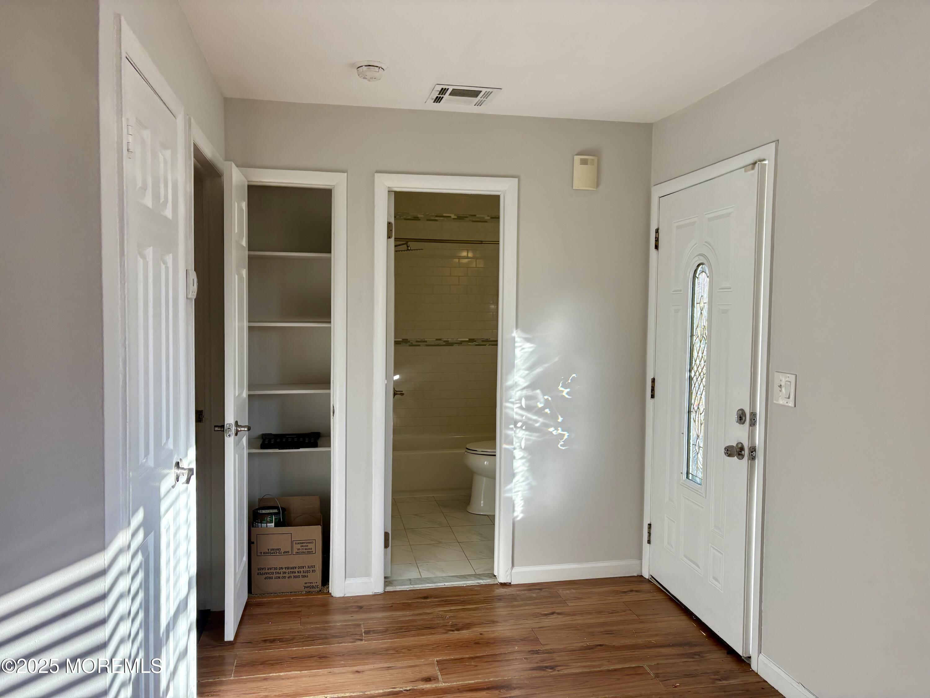 4 A Primrose Lane Jackson, NJ 08527 - Photo 11 of 14 a view of a hallway with wooden floor and closet area