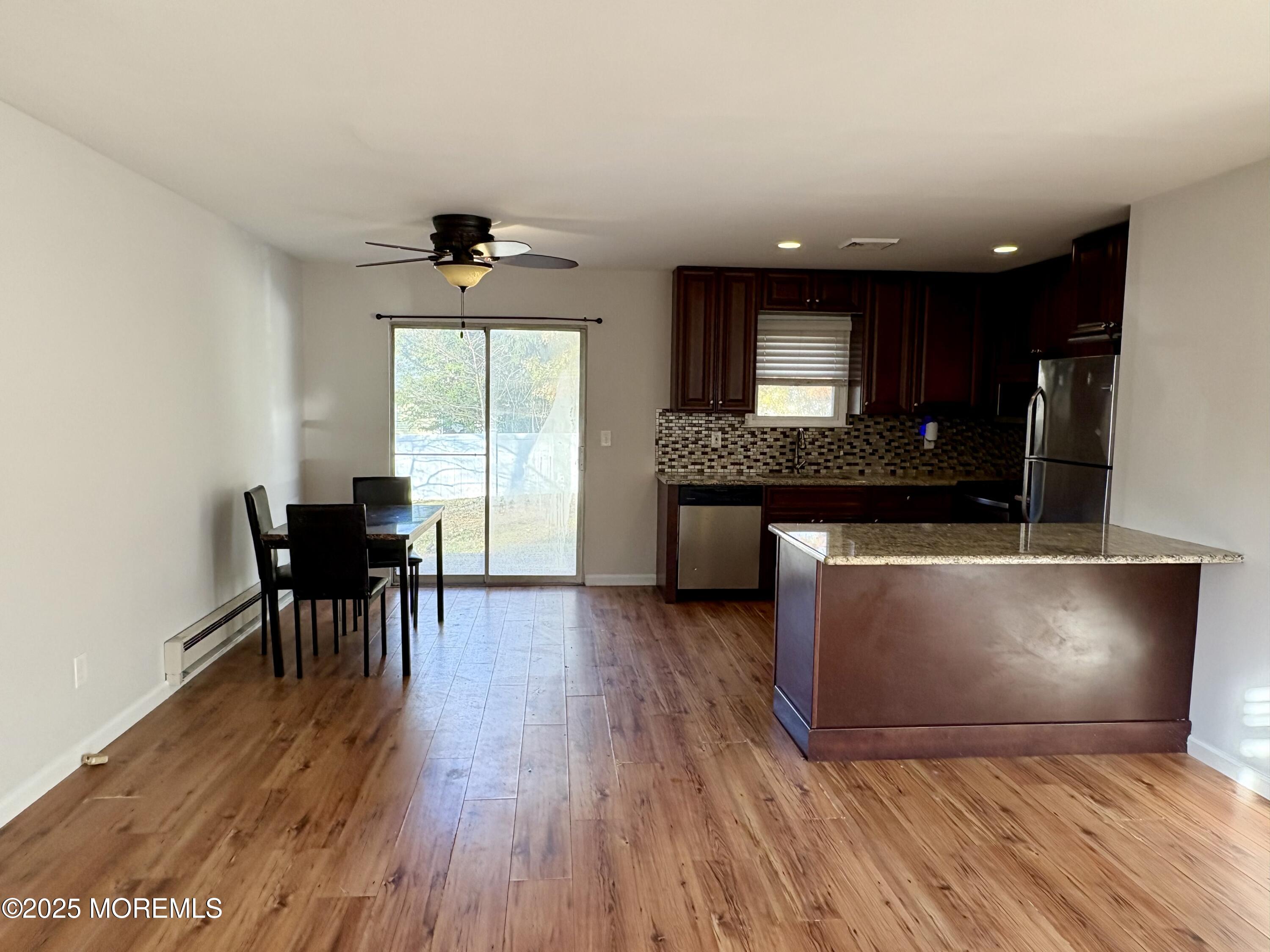 4 A Primrose Lane Jackson, NJ 08527 - Photo 3 of 14 a living room with furniture a large window and wooden floor