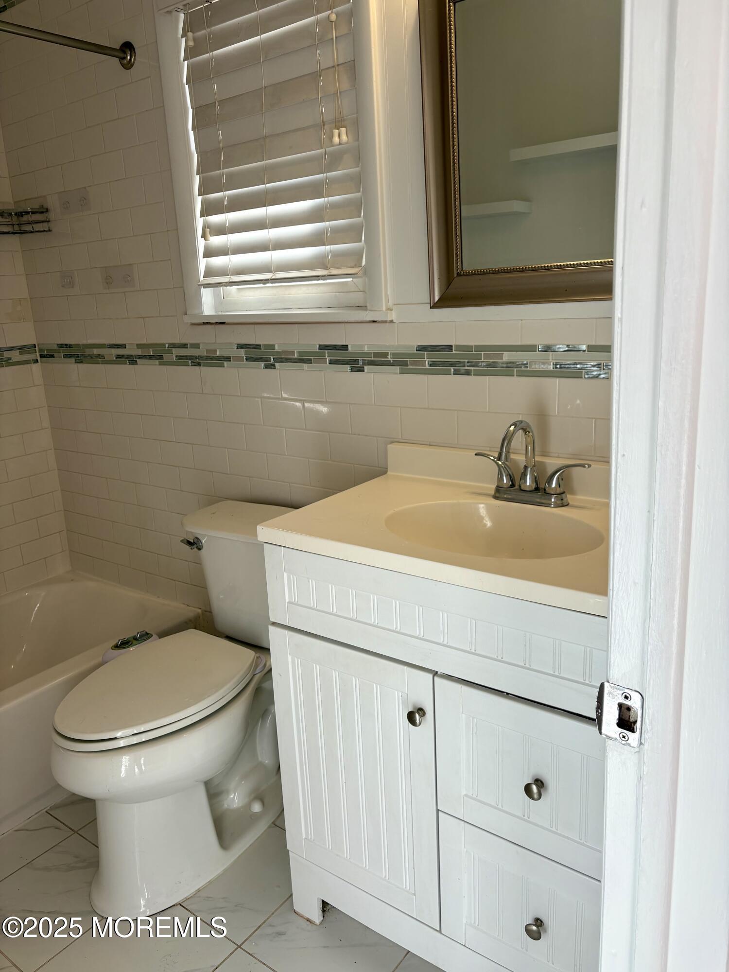 4 A Primrose Lane Jackson, NJ 08527 - Photo 9 of 14 a bathroom with a sink a toilet and a window