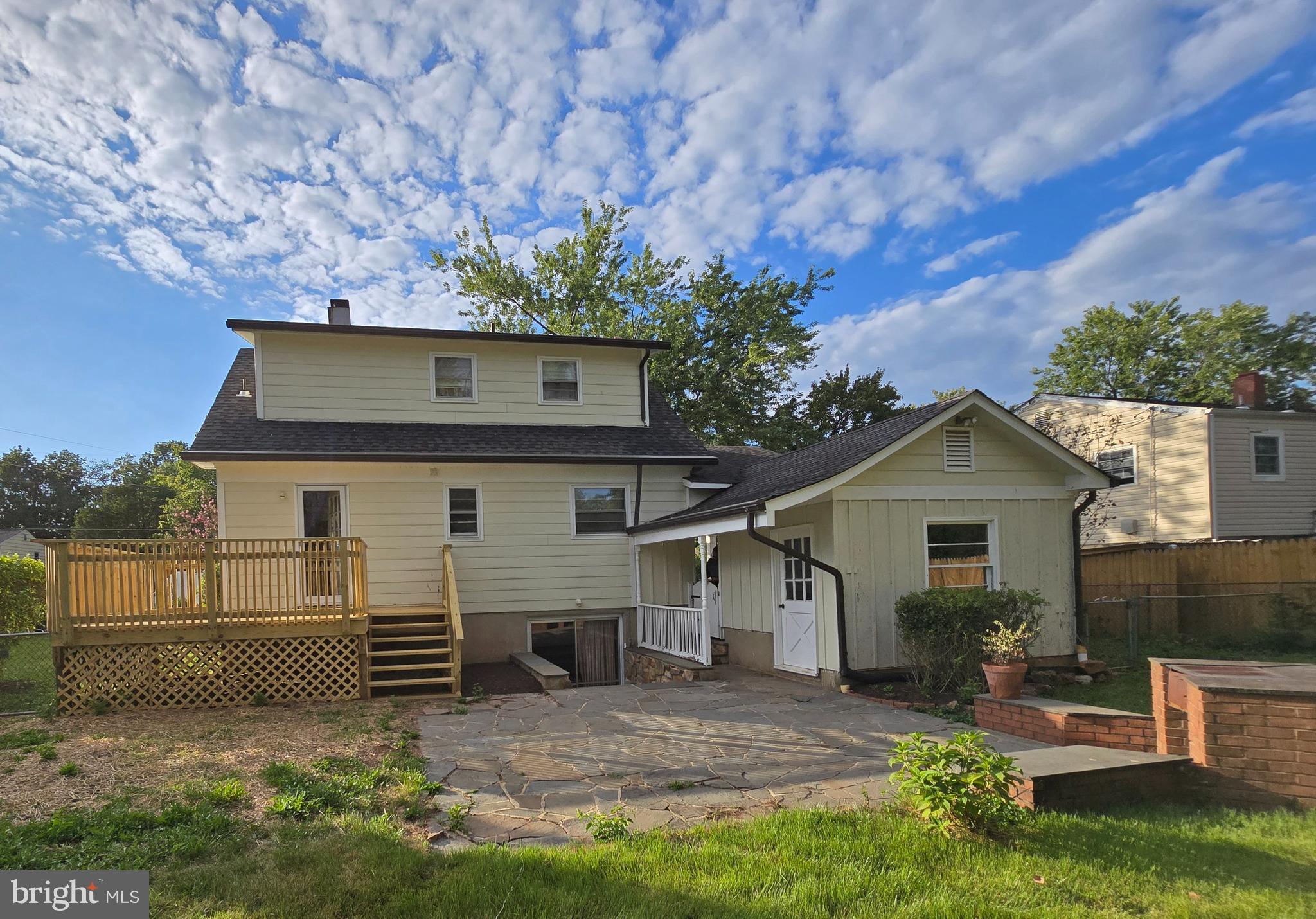 Fenced flat back yard with slate patio