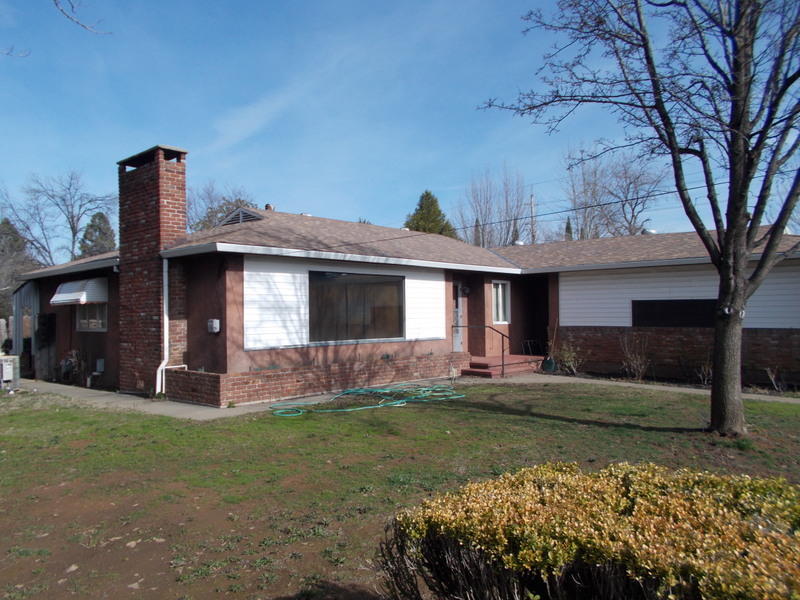 2774 North Bonnyview Road Redding, CA 96001 - Photo 1 of 36 a front view of a house with a garden and yard