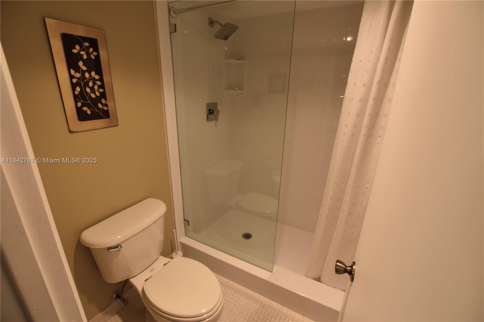3800 Oaks Clubhouse Drive, Unit 309 Pompano Beach, FL 33069 - Photo 12 of 47 a white toilet sitting next to a shower