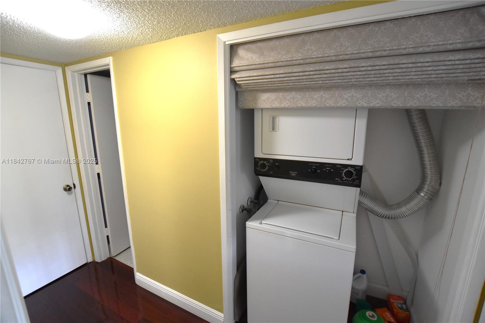 3800 Oaks Clubhouse Drive, Unit 309 Pompano Beach, FL 33069 - Photo 13 of 47 a utility room with a washer and dryer