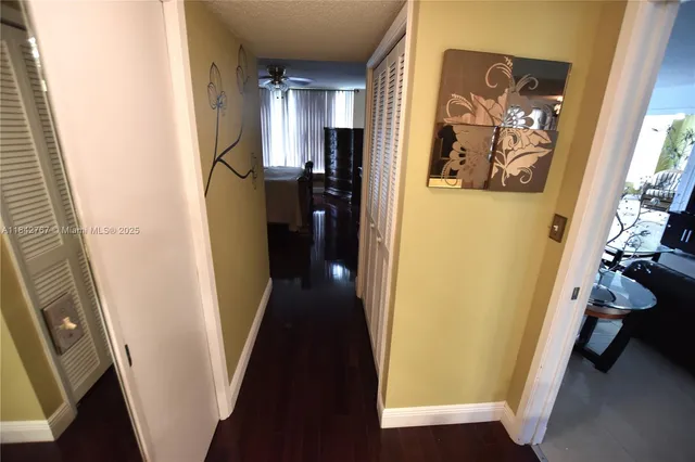 a view of a hallway with wooden floor and stairs