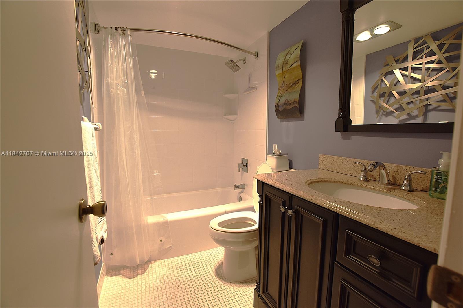 3800 Oaks Clubhouse Drive, Unit 309 Pompano Beach, FL 33069 - Photo 17 of 47 a bathroom with a granite countertop sink toilet and shower