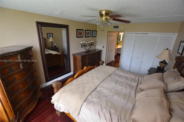 a bed room with a bed and a mirror