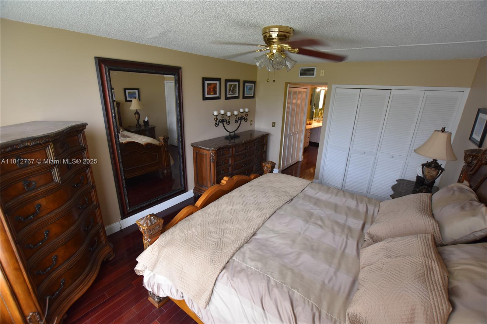 3800 Oaks Clubhouse Drive, Unit 309 Pompano Beach, FL 33069 - Photo 10 of 47 a bed room with a bed and a mirror