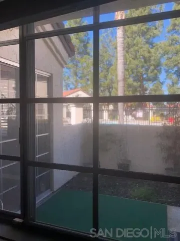 a view of a glass door with a yard