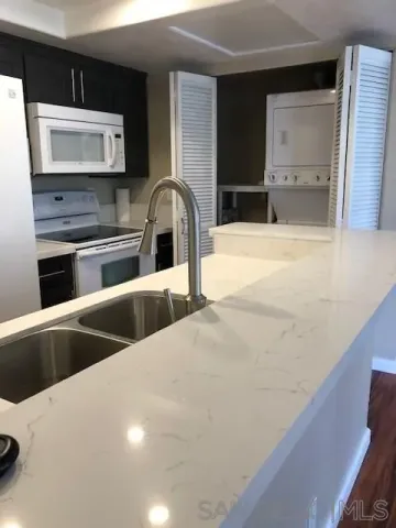 a kitchen with stainless steel appliances kitchen island a sink a stove and cabinets