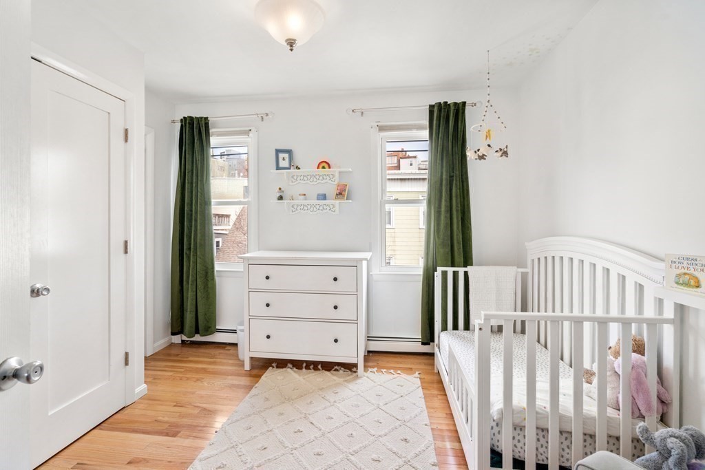 48-50 Russell Street, Unit 3A Boston, MA 02129 - Photo 8 of 11 a view of a bedroom with baby bed