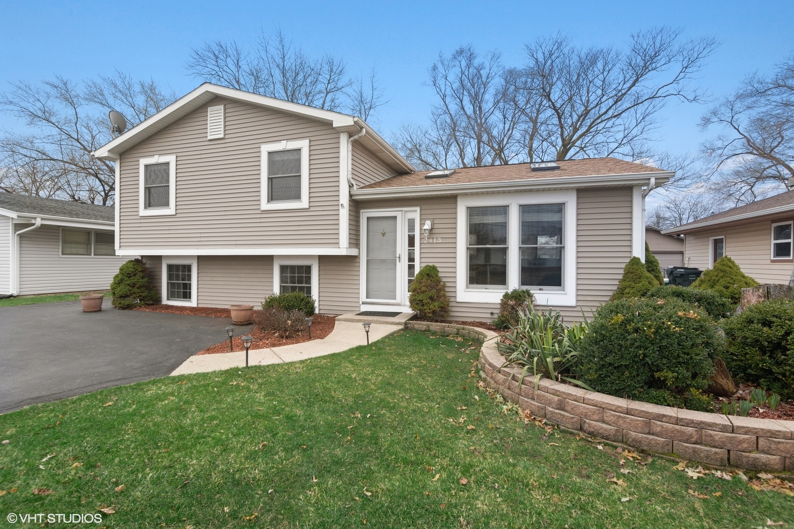 2413 Sand Lake Road Lindenhurst, IL 60046 - Photo 1 of 14 a front view of house with a garden and patio