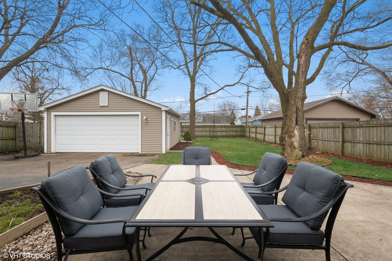 2413 Sand Lake Road Lindenhurst, IL 60046 - Photo 14 of 14 a view of a patio with table and chairs and a barbeque with wooden fence and floor