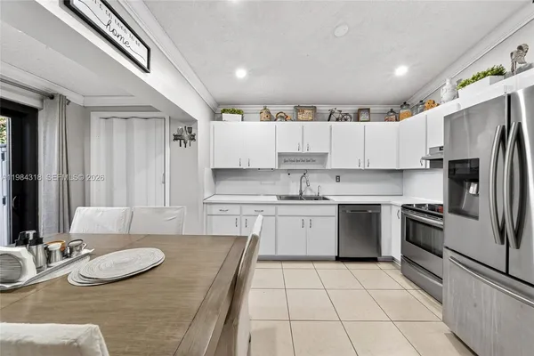 a kitchen with stainless steel appliances granite countertop a sink and cabinets