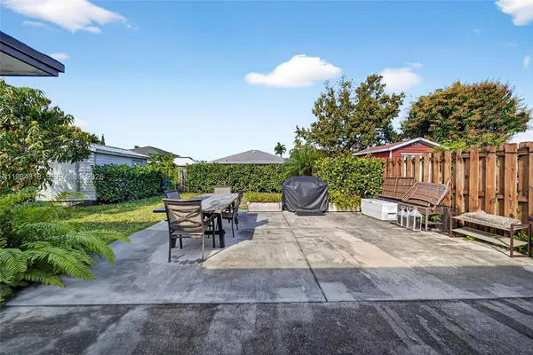 a view of a backyard with sitting area