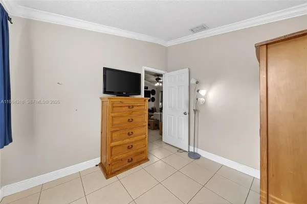 a view of room with cabinet and flat screen tv