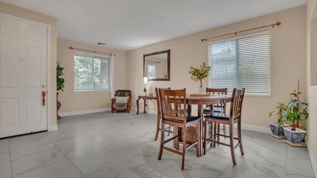 a view of a dining room with furniture and window