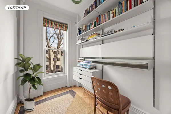 a kitchen with furniture and a potted plant