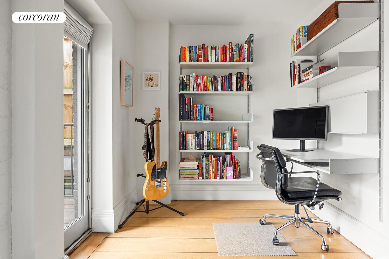 369 6th Street Brooklyn, NY 11215 - Photo 15 of 22 a view of a workspace with furniture and a book shelf