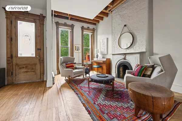 a living room with furniture a fireplace and wooden floor
