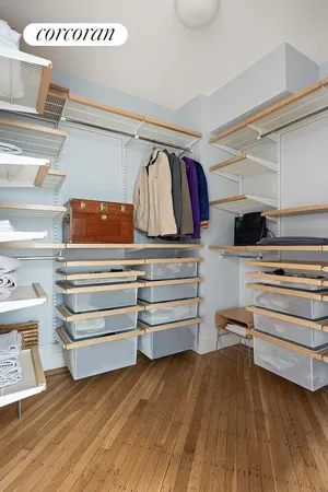 a view of walk in closet with empty racks