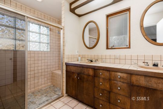 1029 Leslie Street Ridgecrest, CA 93555 - Photo 21 of 40 a bathroom with a double vanity sink mirror and a mirror