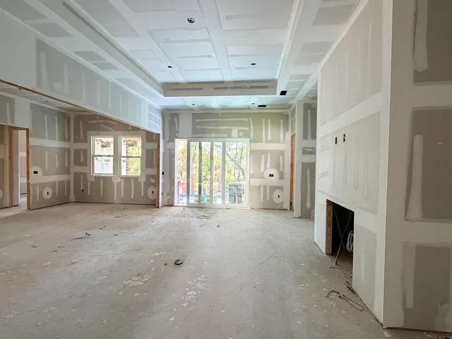 a view of a livingroom with furniture and floor to ceiling window