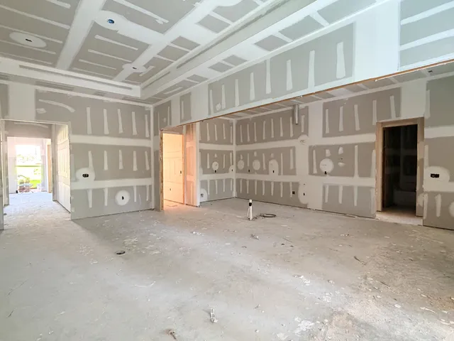 a view of an empty room with a fireplace and a window