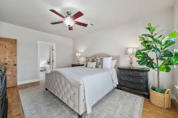 a bedroom with bed and a potted plant